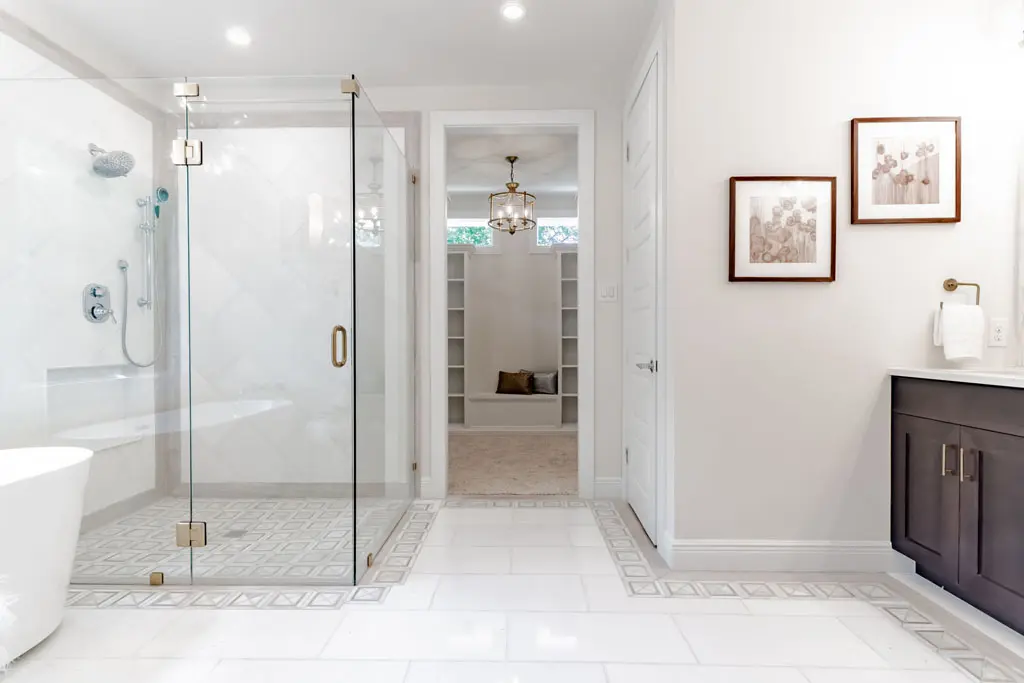 Luxury master bathroom renovation with frameless glass shower and freestanding tub in San Antonio TX