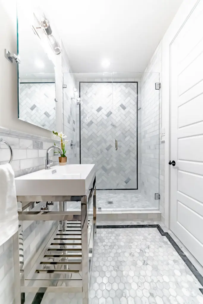 Contemporary guest bathroom with marble herringbone tile shower and hexagon floor in San Antonio TX