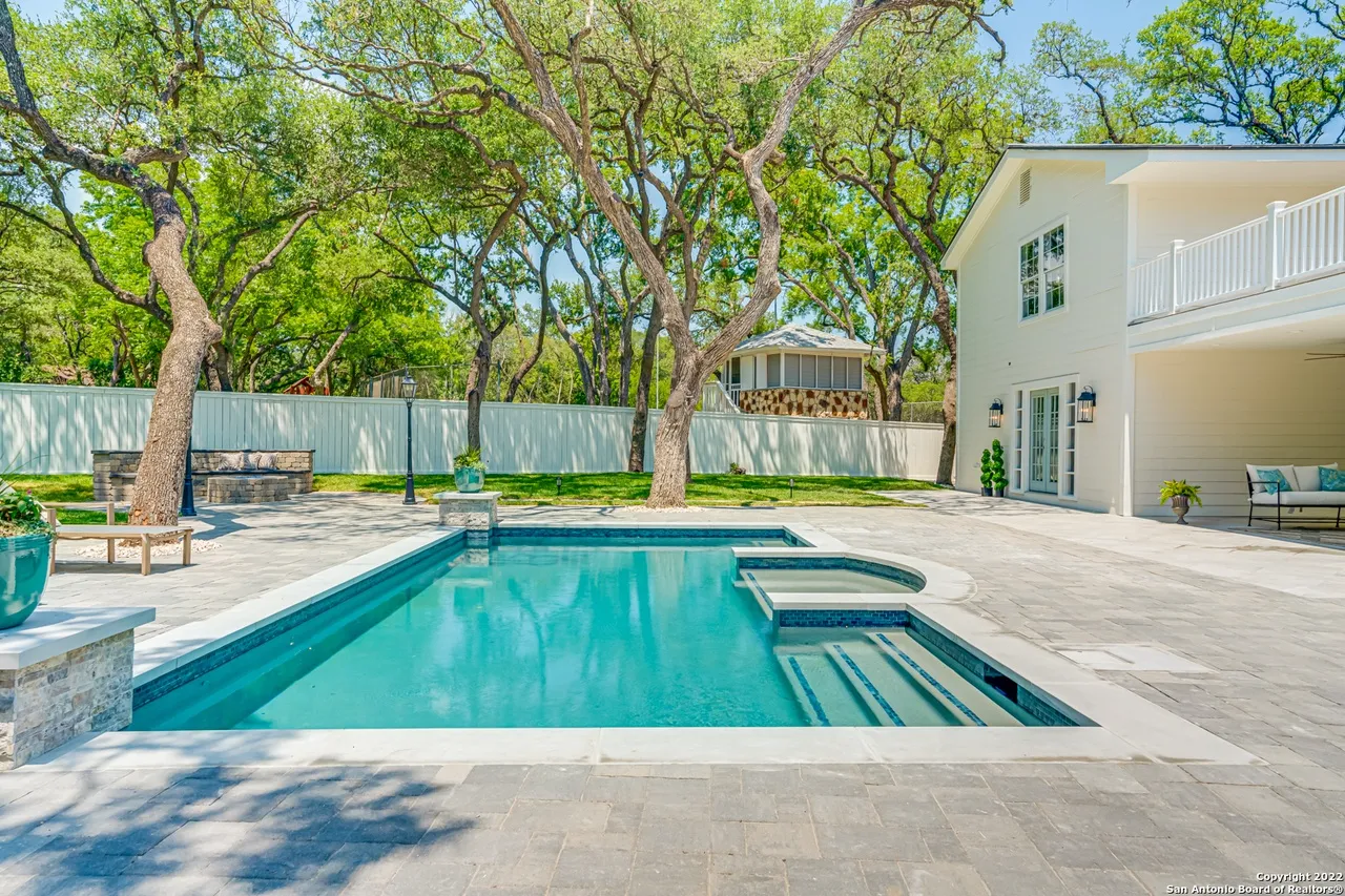 Castle Hills Manor backyard remodel with new pool, spa, stone fire pit seating area, and limestone patio pavers in San Antonio TX