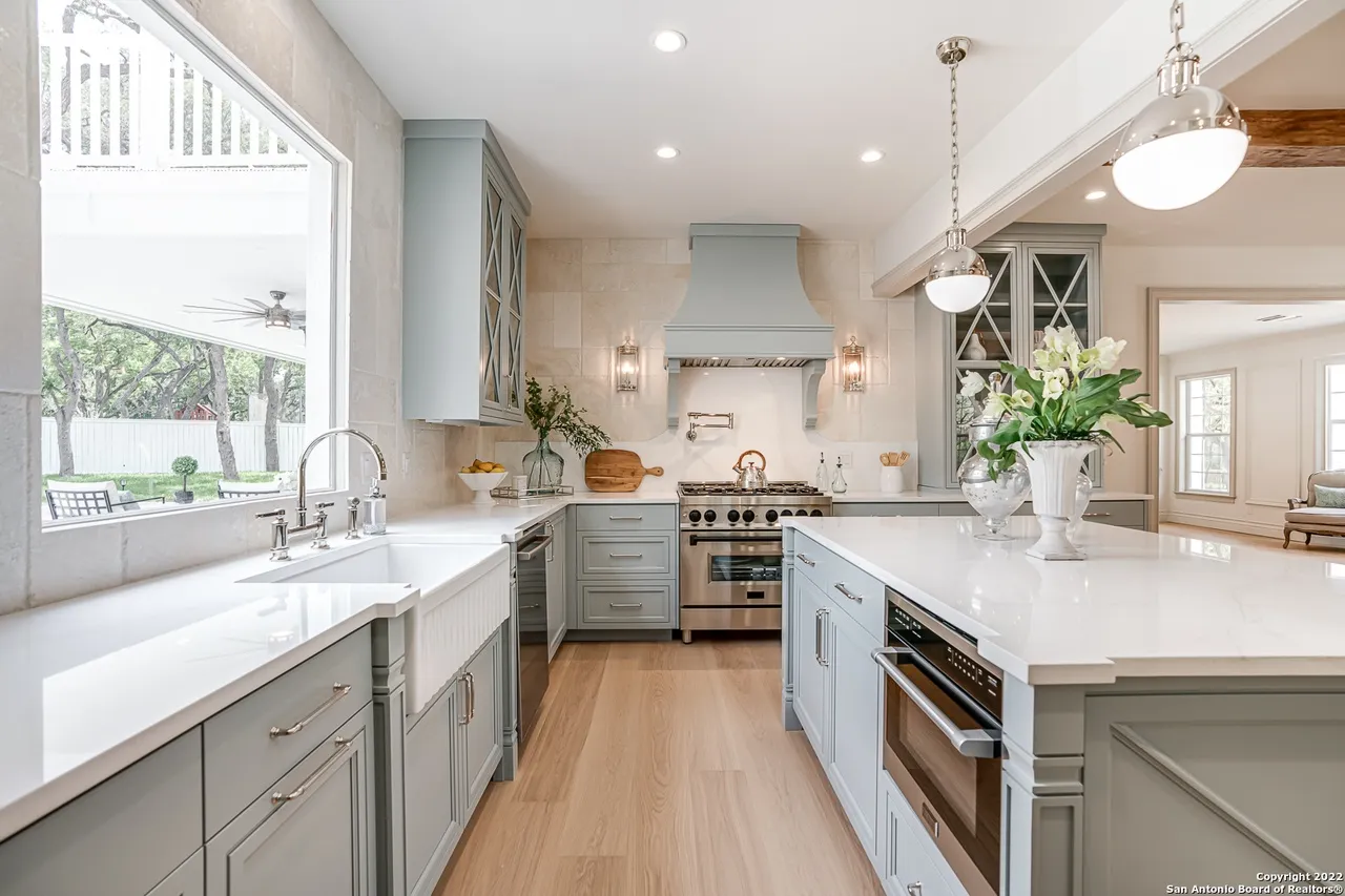 Castle Hills kitchen remodel with farmhouse sink, professional gas range, and custom sage cabinetry in San Antonio TX