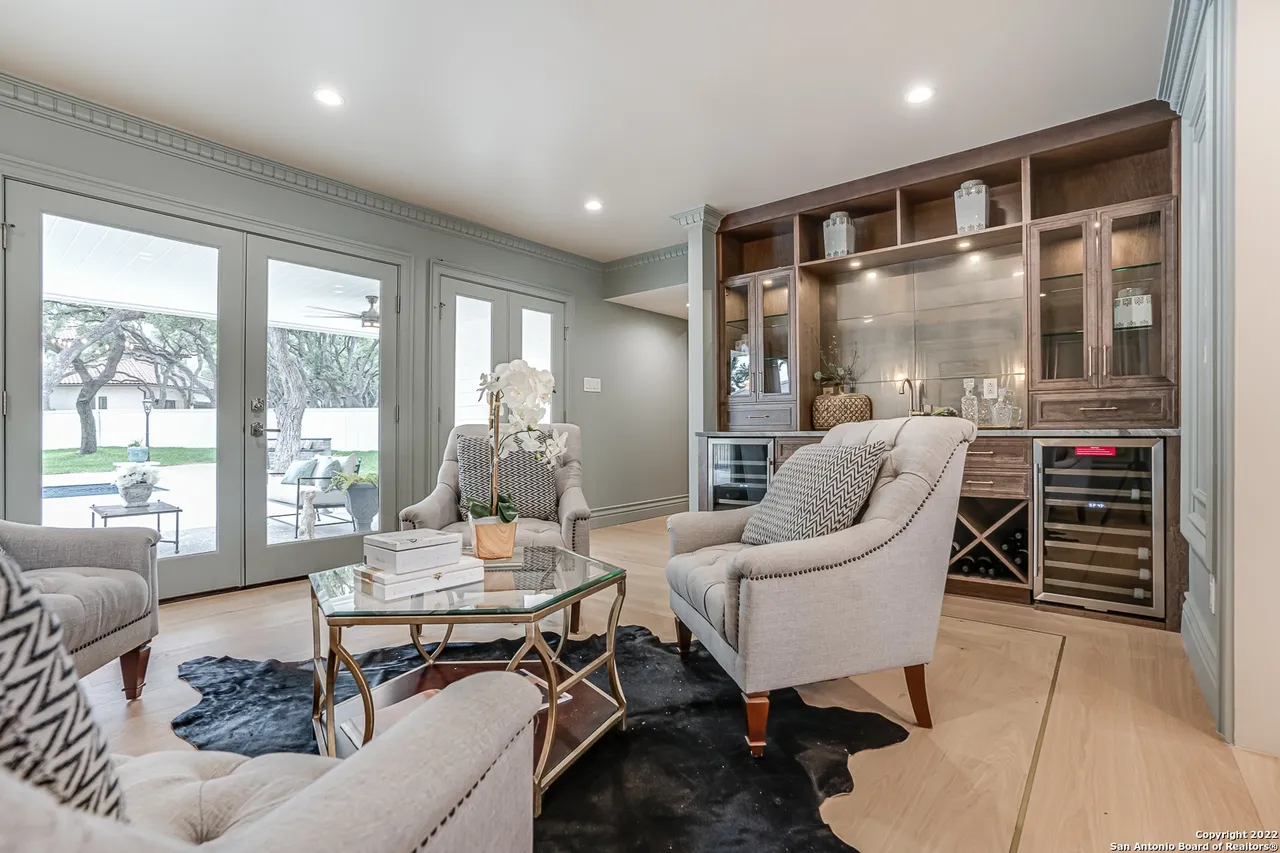 Remodeled sitting room with built-in bar, dual wine coolers, and French doors to backyard in Castle Hills San Antonio TX