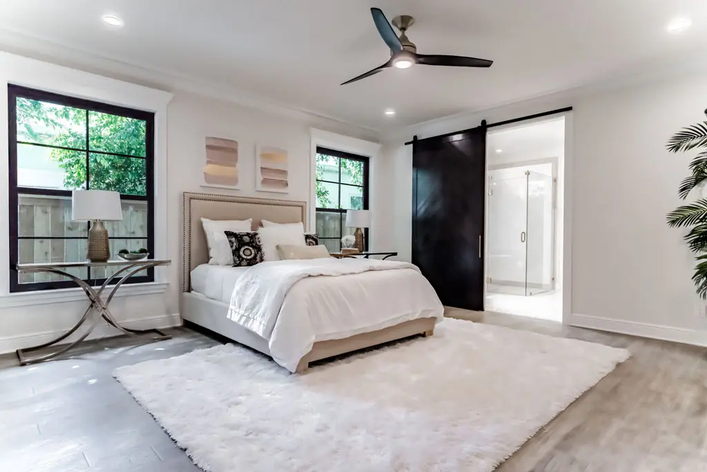 Modern master bedroom renovation with barn door ensuite, recessed lighting, and luxury finishes in San Antonio TX